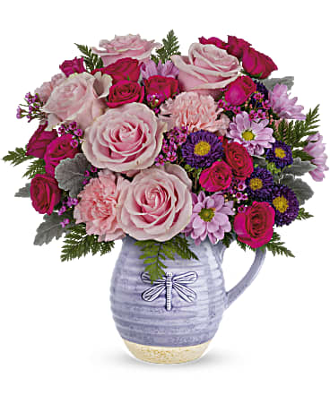 Pink and magenta mixed bouquet in a lavender pitcher vase