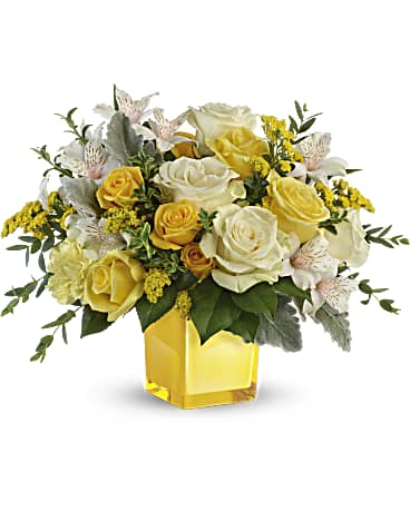 Yellow and white rose bouquet in a square glass vase