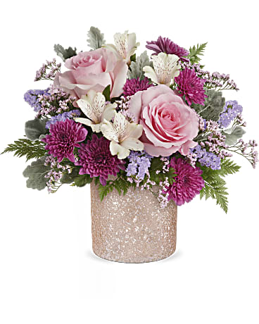 Pink roses and purple flowers arranged in a glittery vase