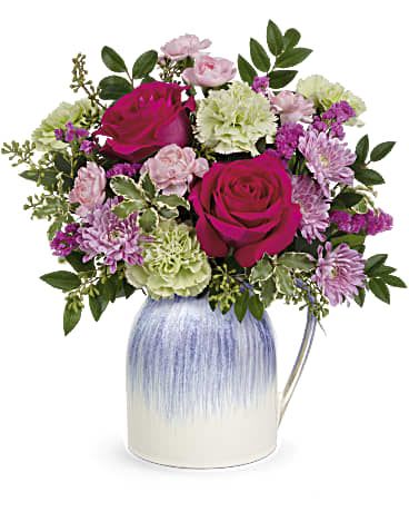 Pink and lavender mixed bouquet in a blue-and-white vase
