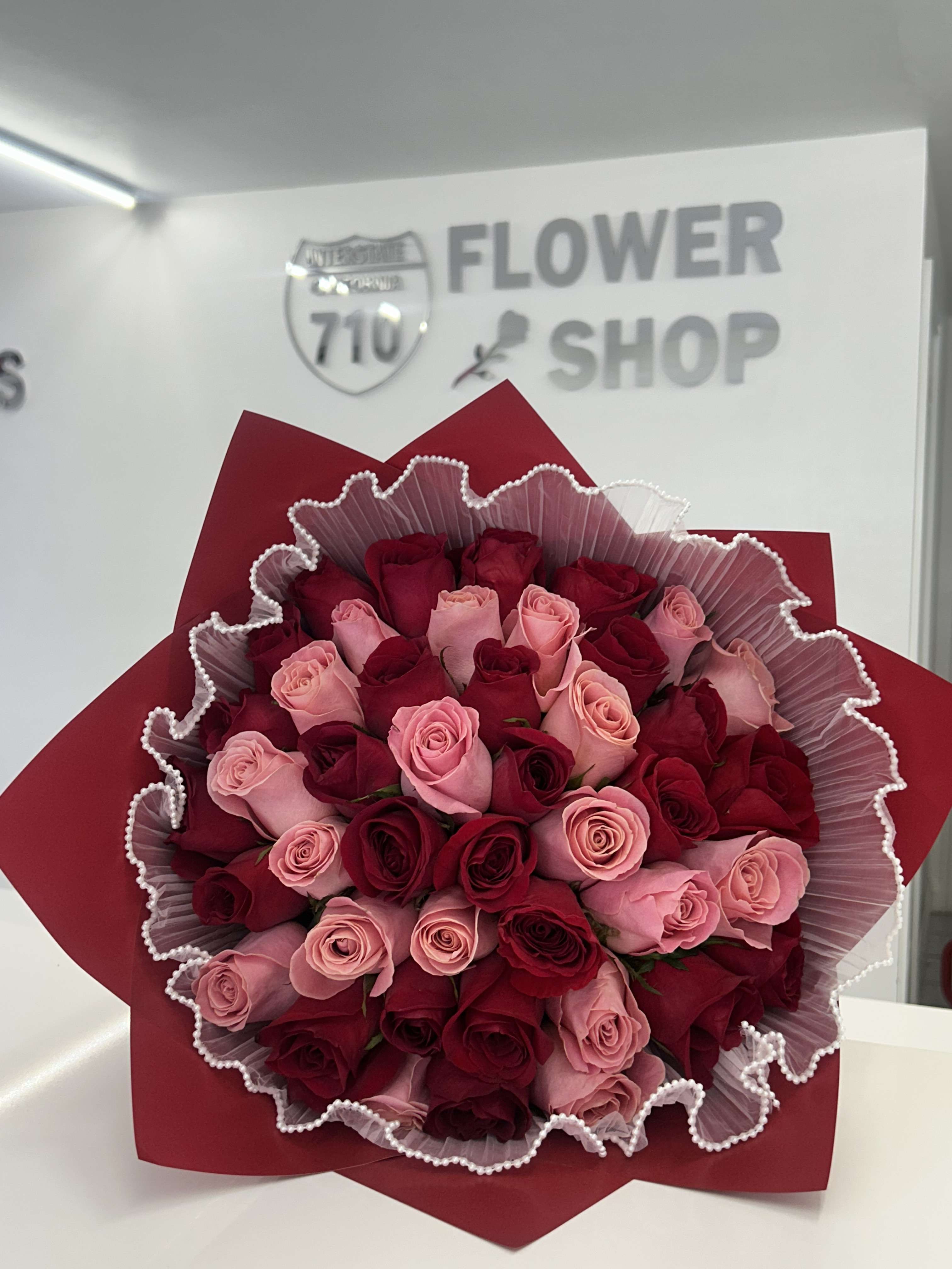Bouquet of red and pink roses wrapped in red paper