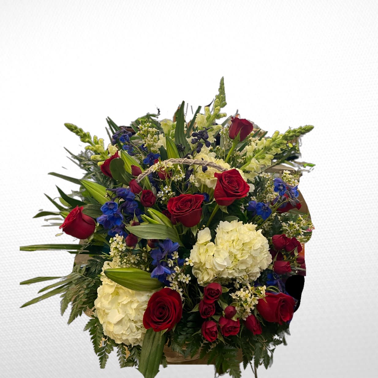 Bouquet of red roses, white hydrangeas, and blue flowers
