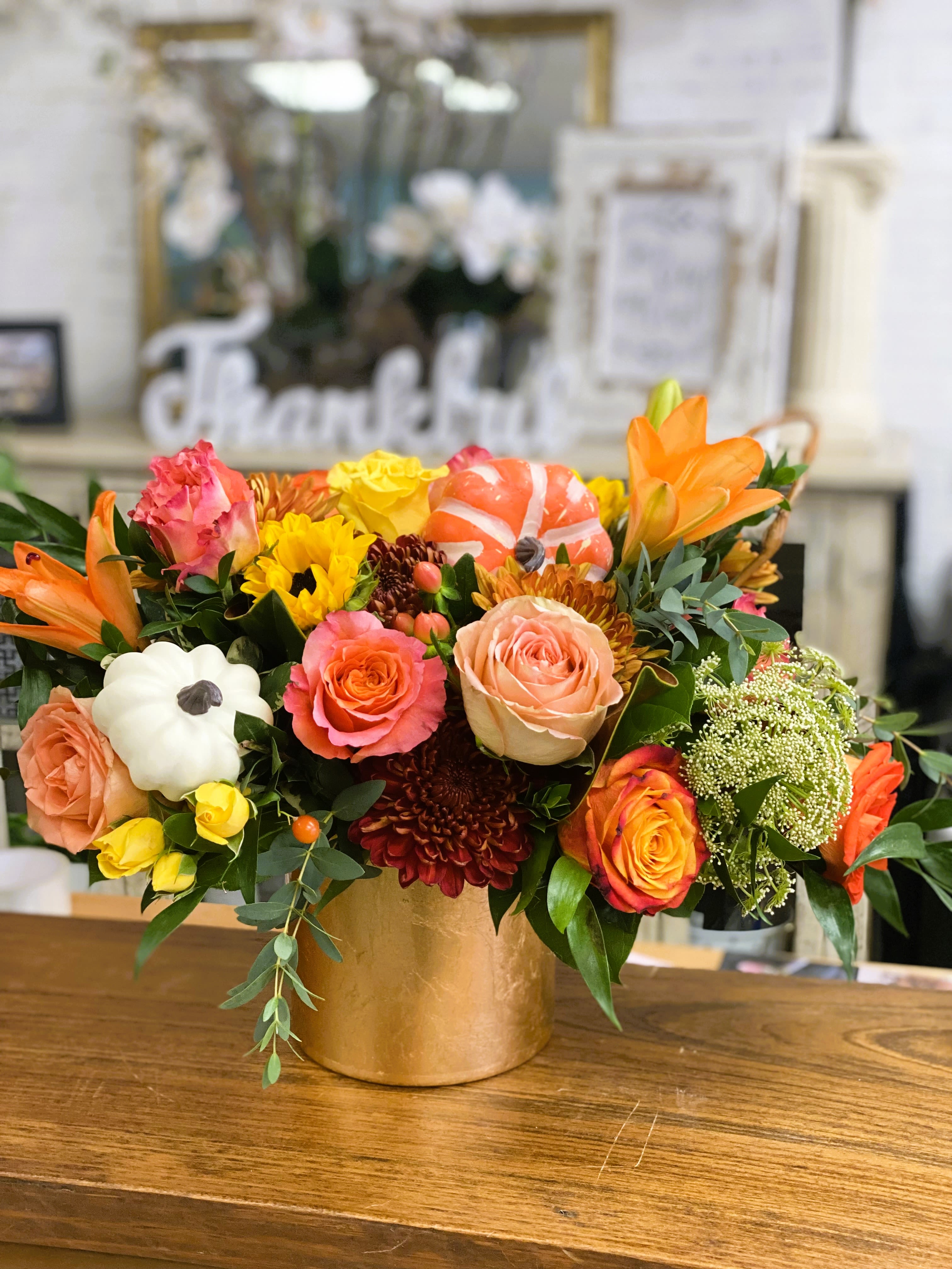 Sweet Potato Pie - Beautiful golden cylinder filled uniquely with warm fall flowers and topped with a pumpkin 