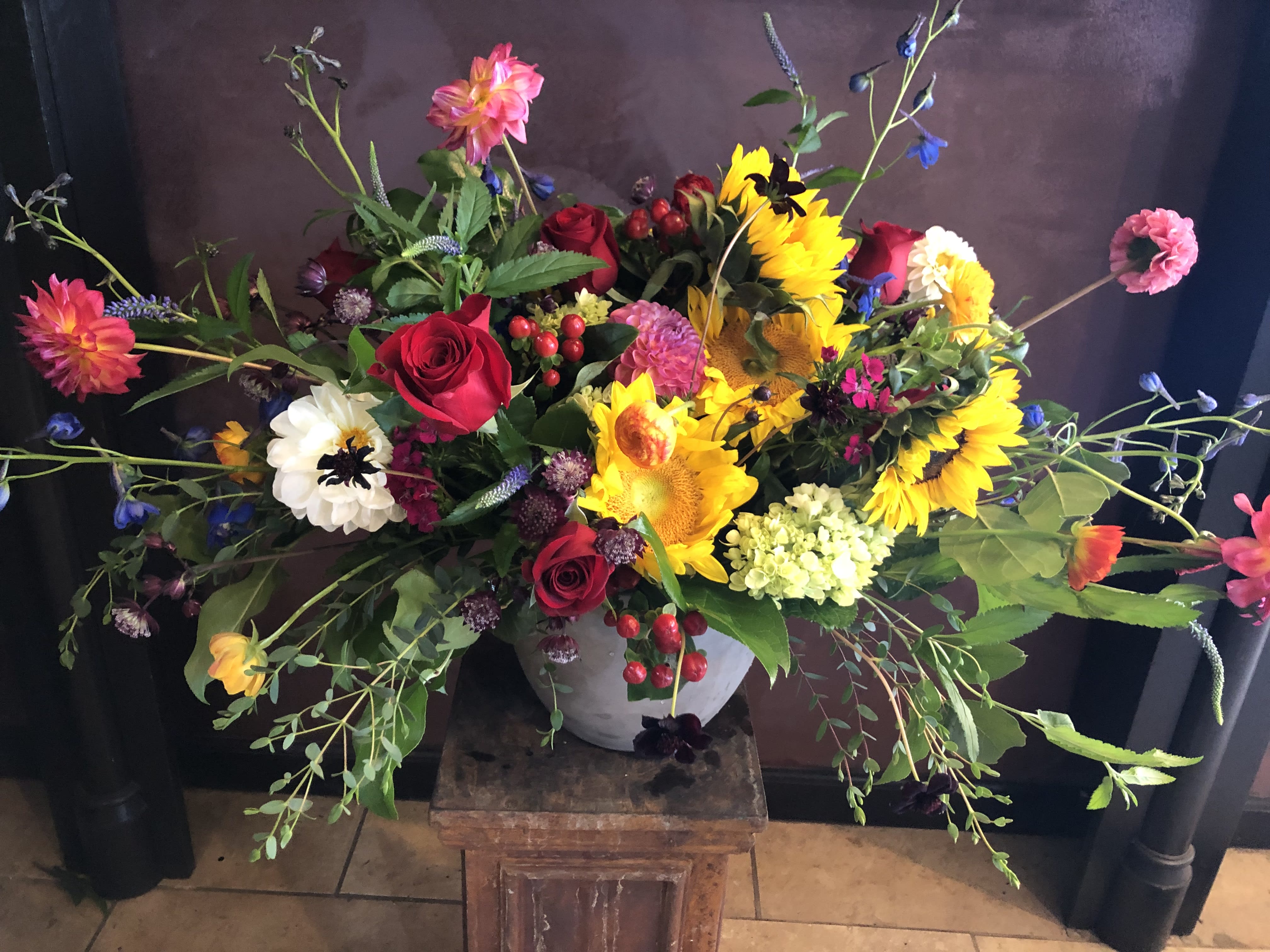 Colorful mixed flower arrangement in a gray vase