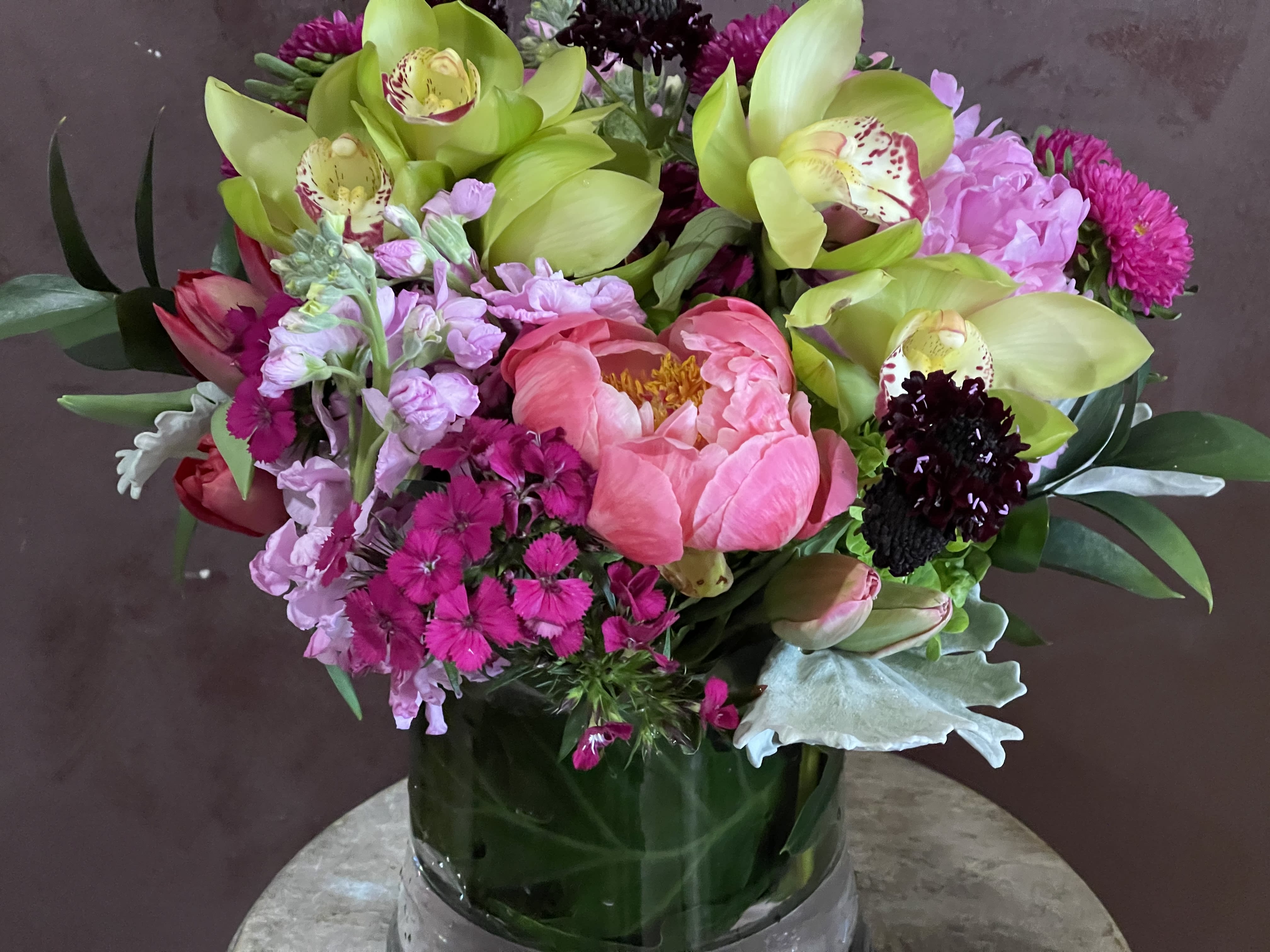 Pink and green mixed bouquet in a glass vase