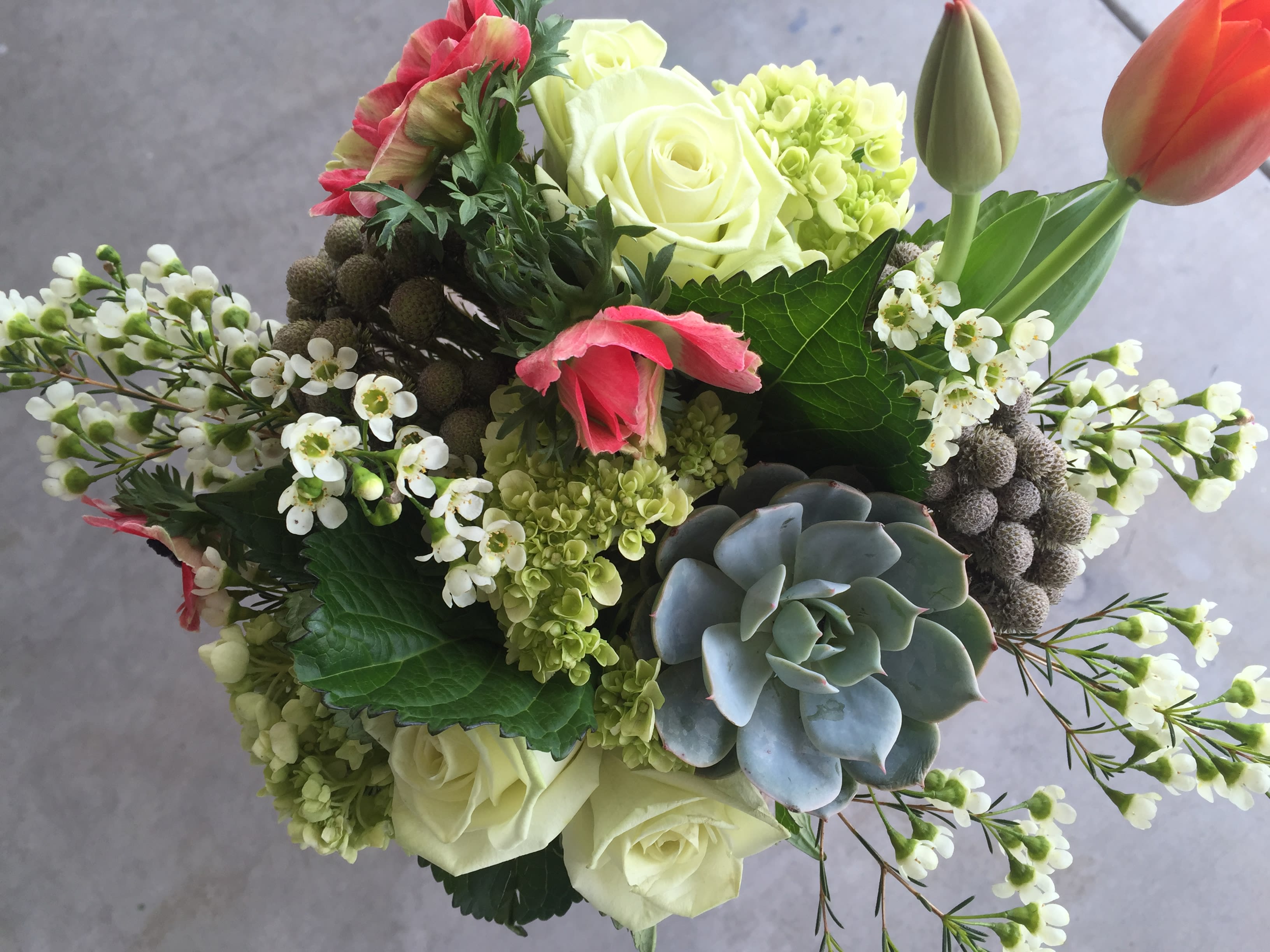 Bouquet with white roses, pink tulips, and a succulent accent