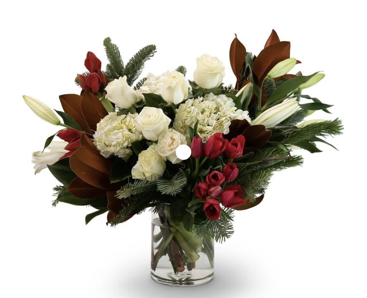 Bouquet of white roses, hydrangeas, and red tulips in a glass vase