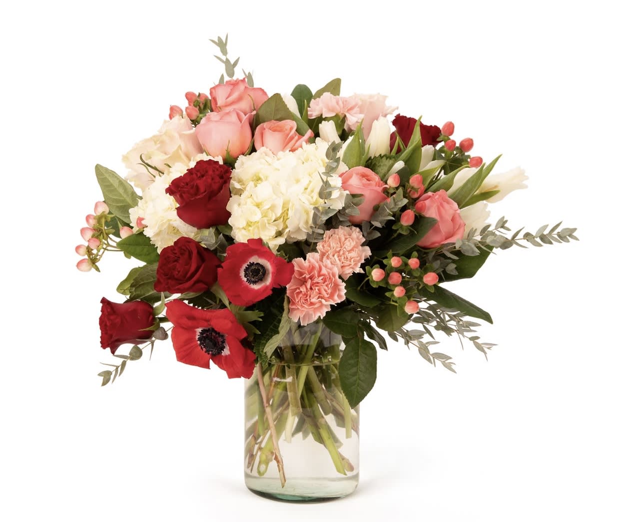 Bouquet of pink and red flowers in a clear glass vase