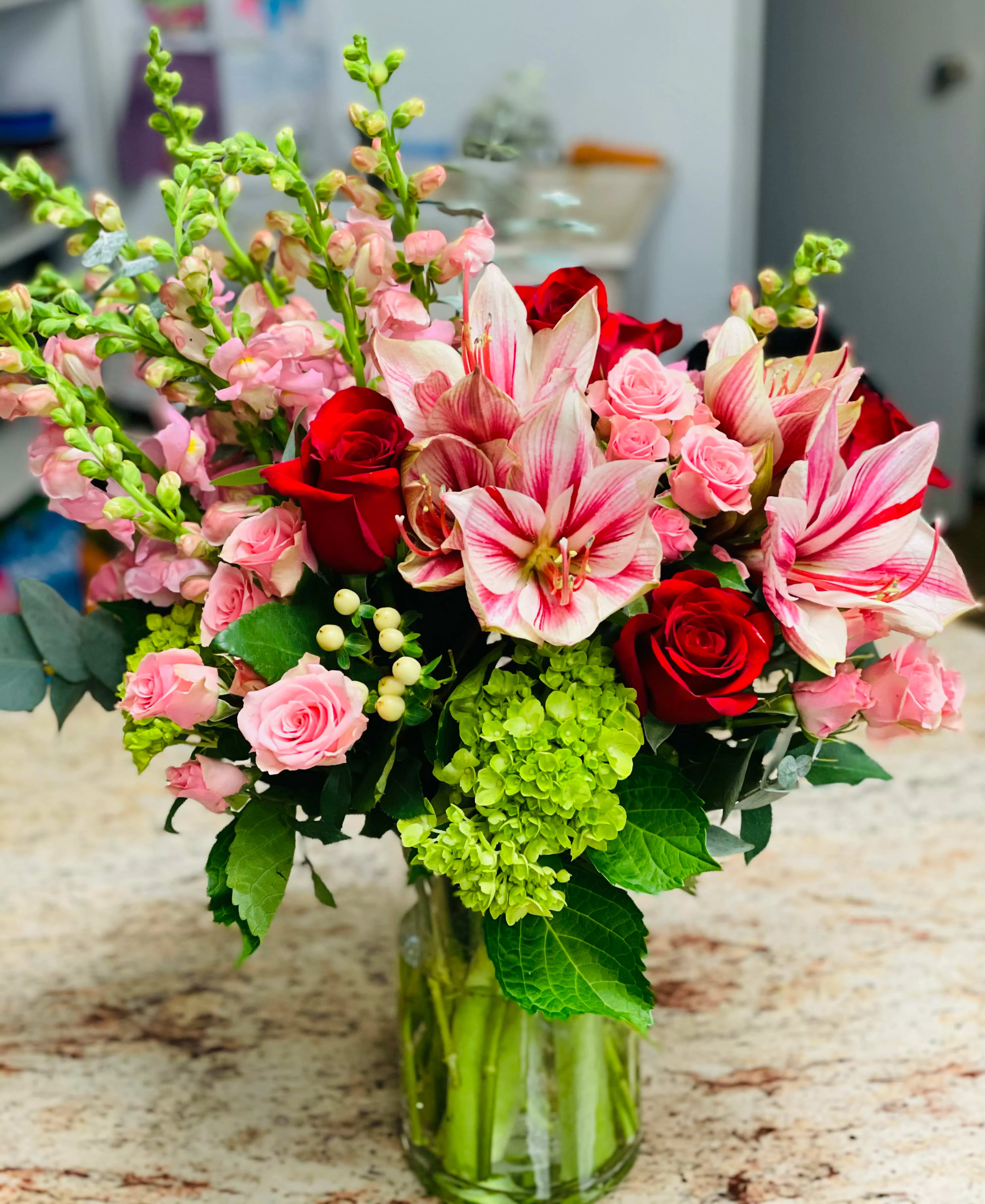 Bouquet of red and pink flowers in a glass vase