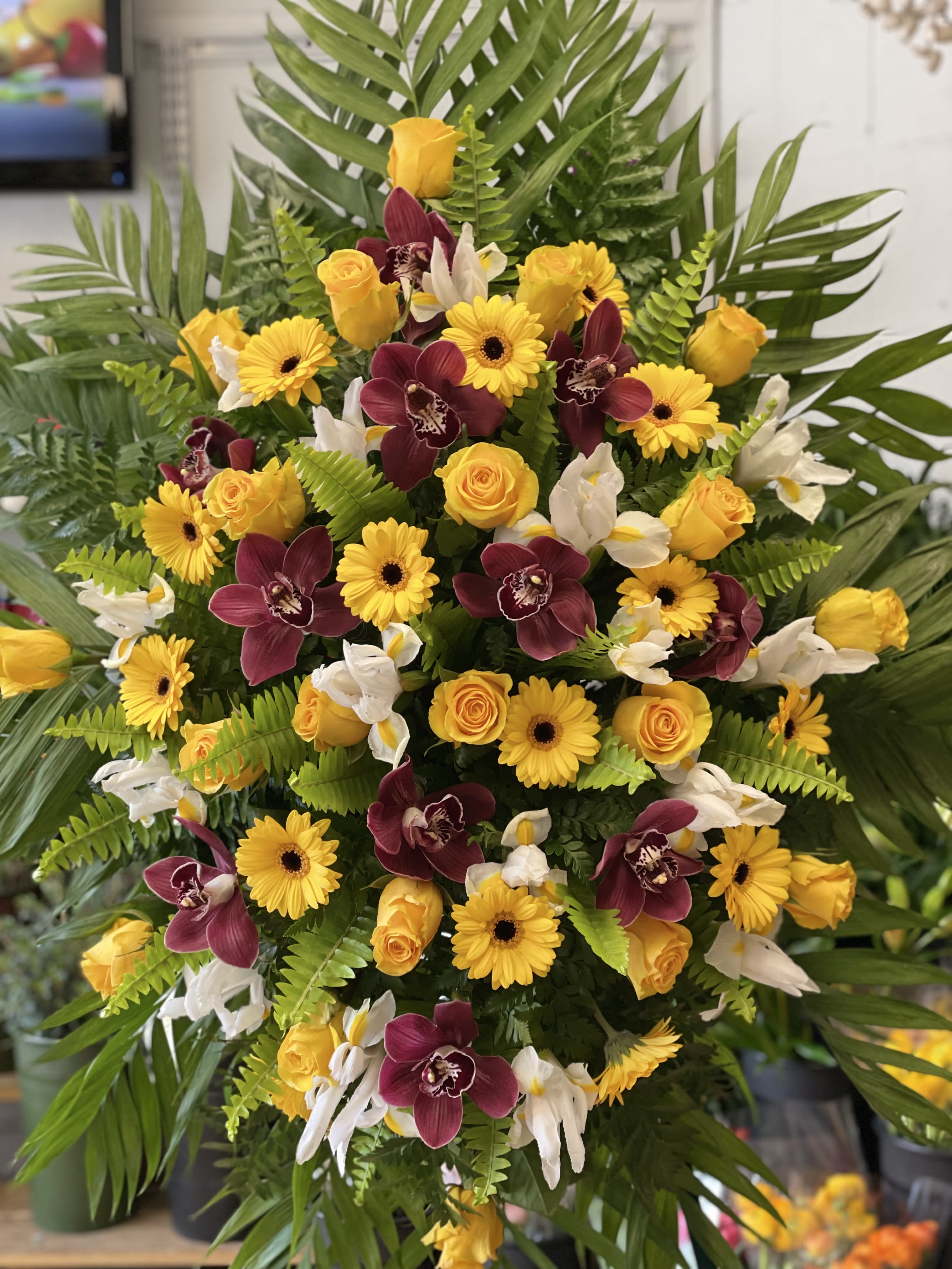 Large tropical bouquet with yellow roses, yellow daisies, and burgundy orchids