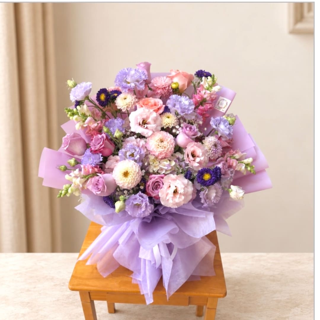 Lavender and pink mixed bouquet wrapped in purple paper