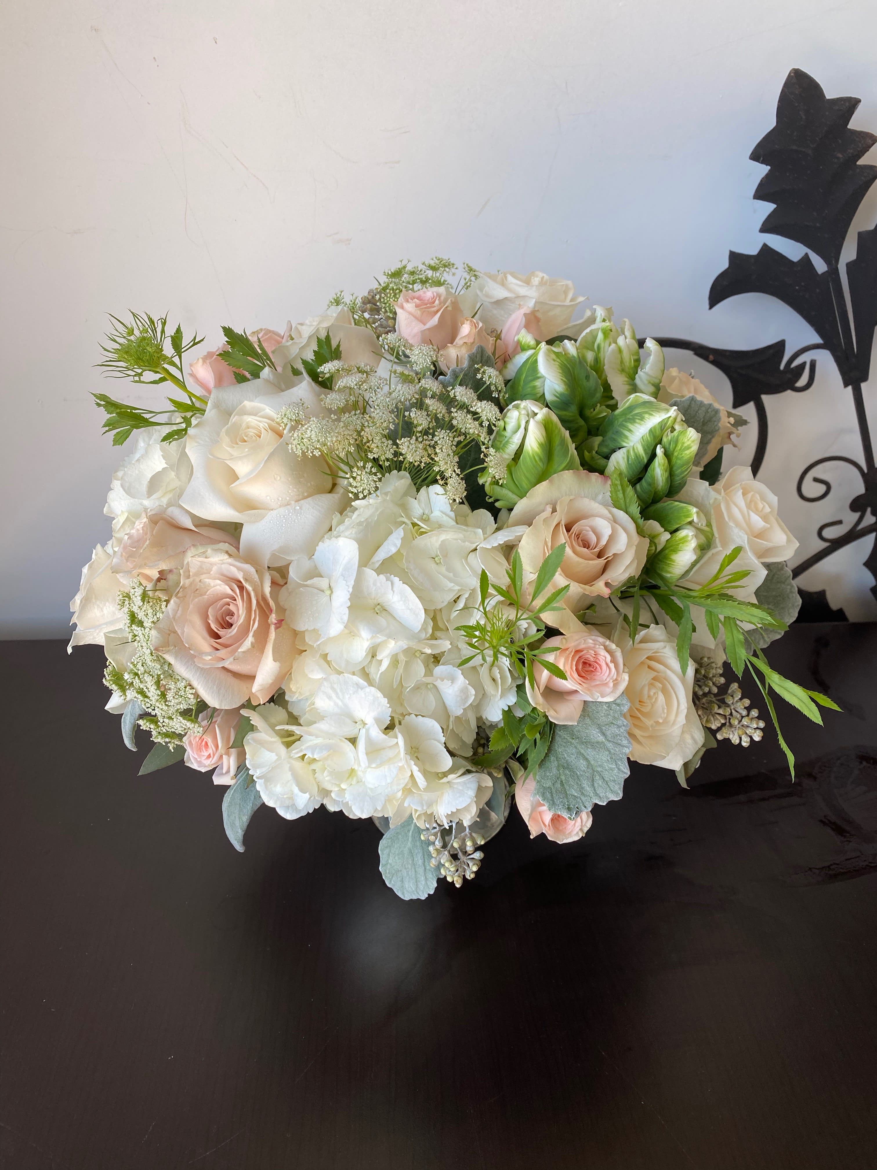 Bouquet of pale roses and white hydrangeas with green accents