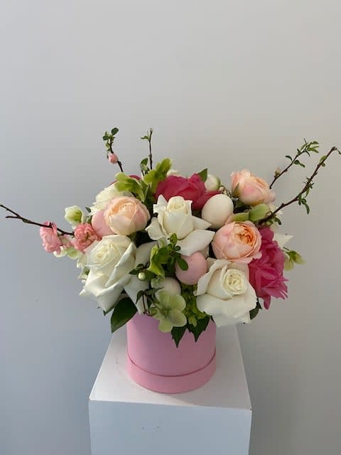 Pink and white rose arrangement in a pink hat box