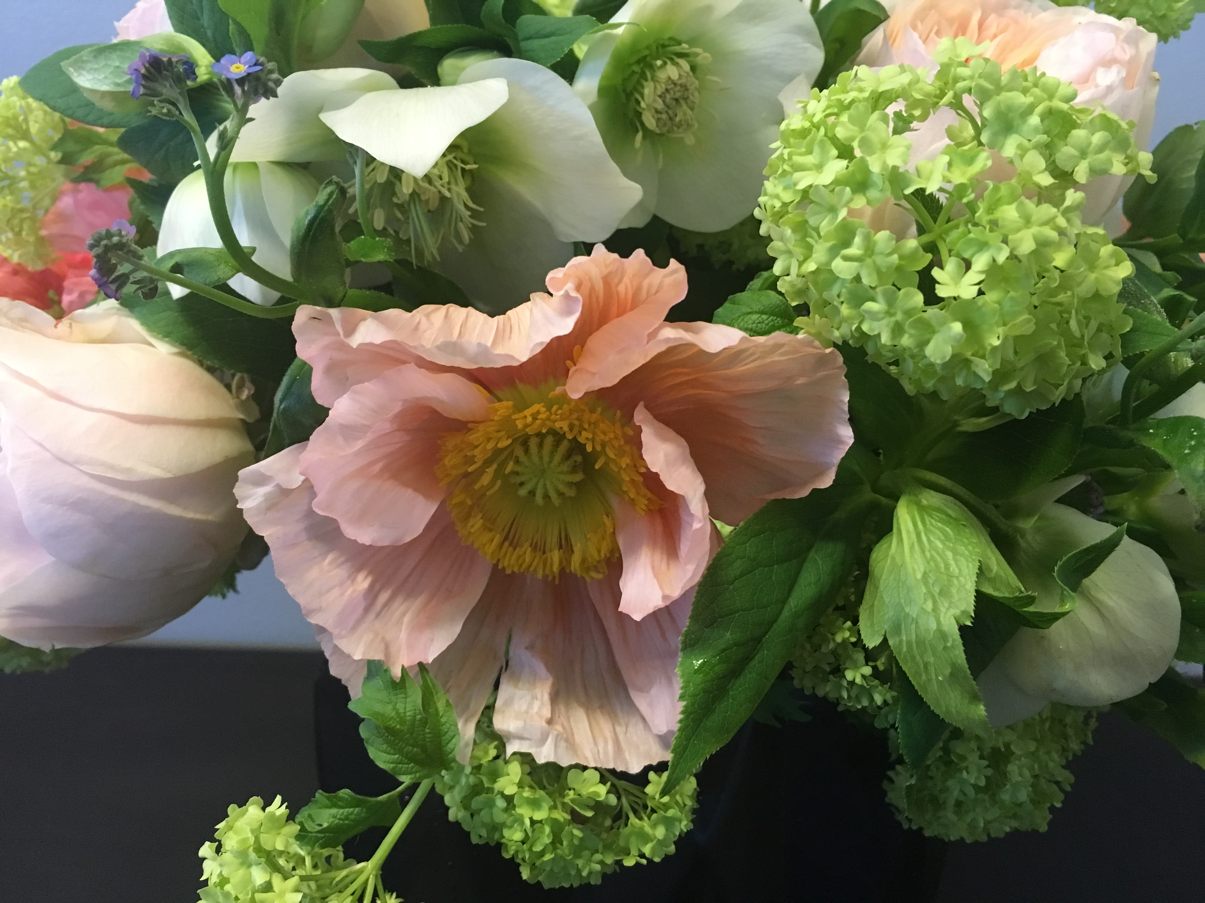 Bouquet of pale pink and white flowers with bright green blooms