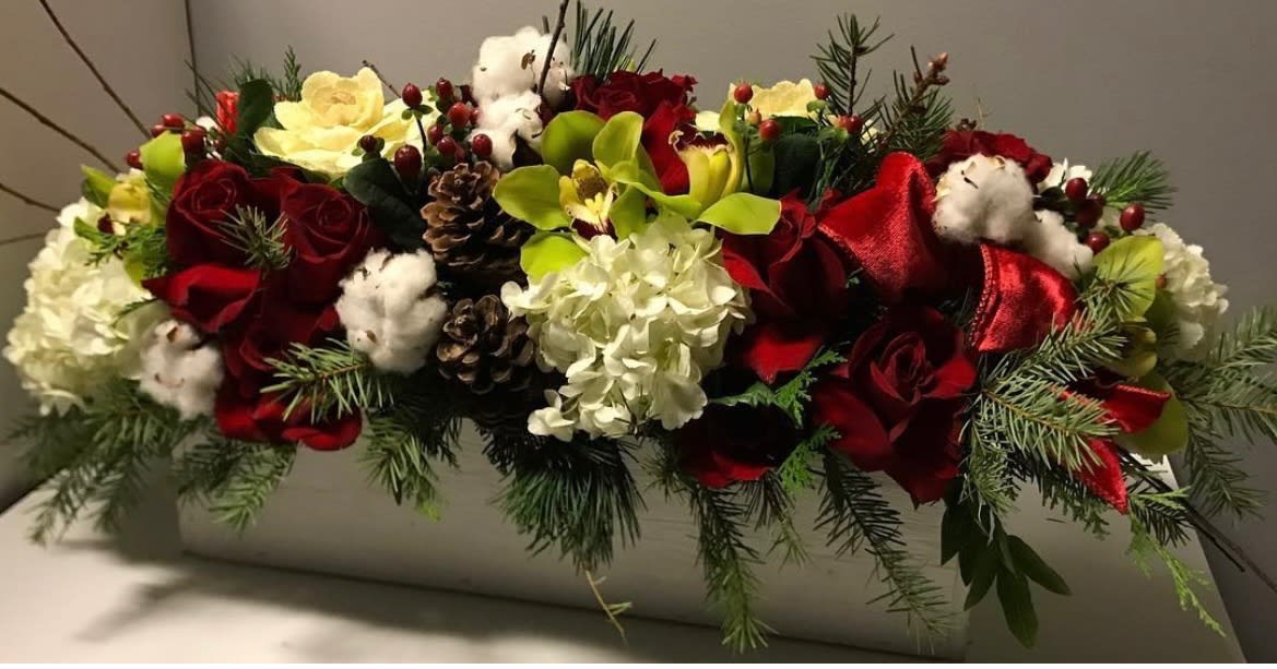 Red roses and white flowers arranged in a rectangular container