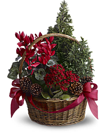 Basket arrangement with red flowers, greenery, pinecones, and red ribbon