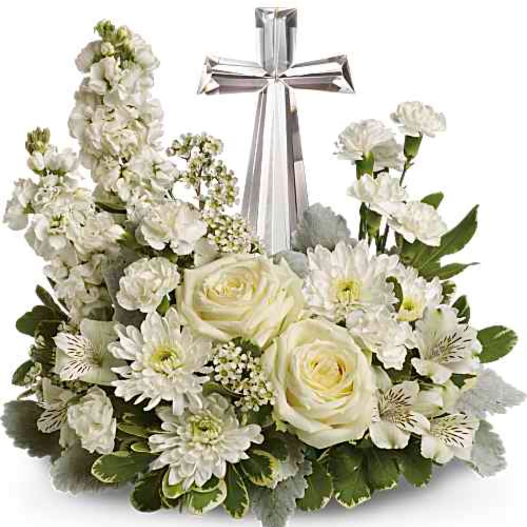 White floral arrangement with a silver cross centerpiece