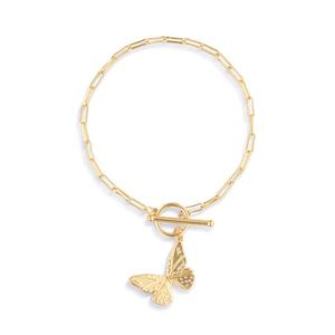 Gold chain necklace with a butterfly charm on a white background