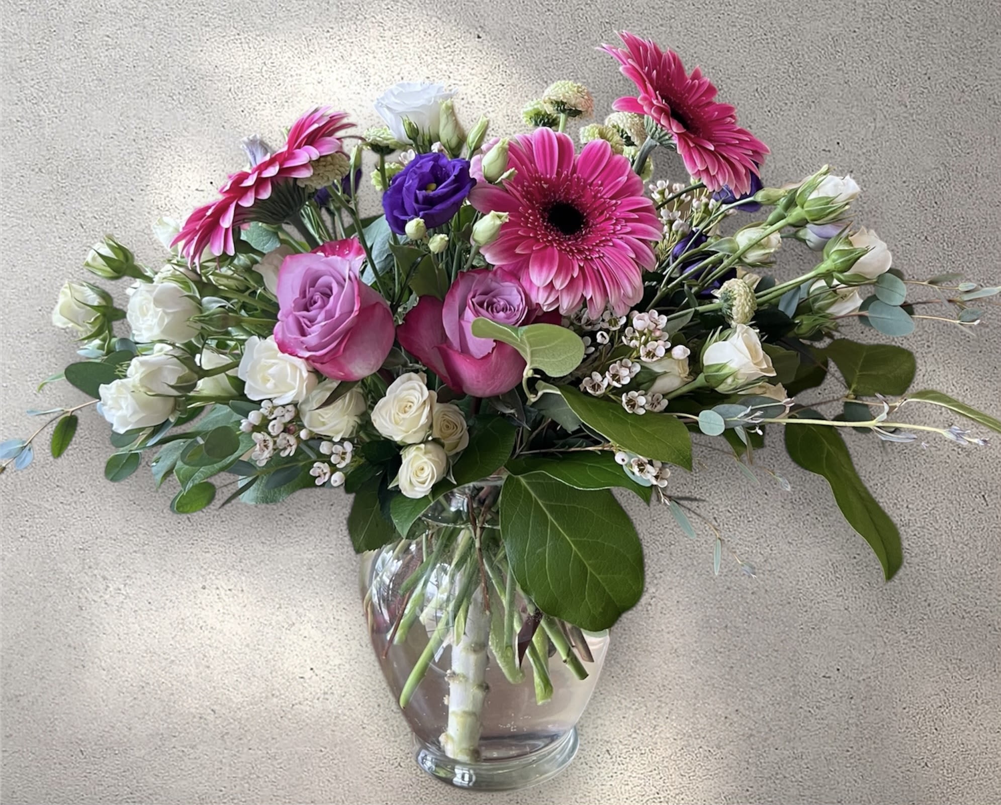 Pink and white mixed bouquet in a clear glass vase