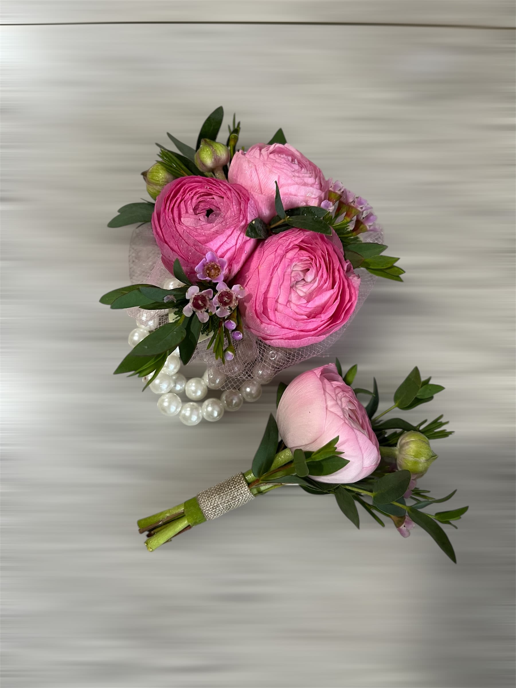 Pink ranunculus bouquet with pearl accents and greenery
