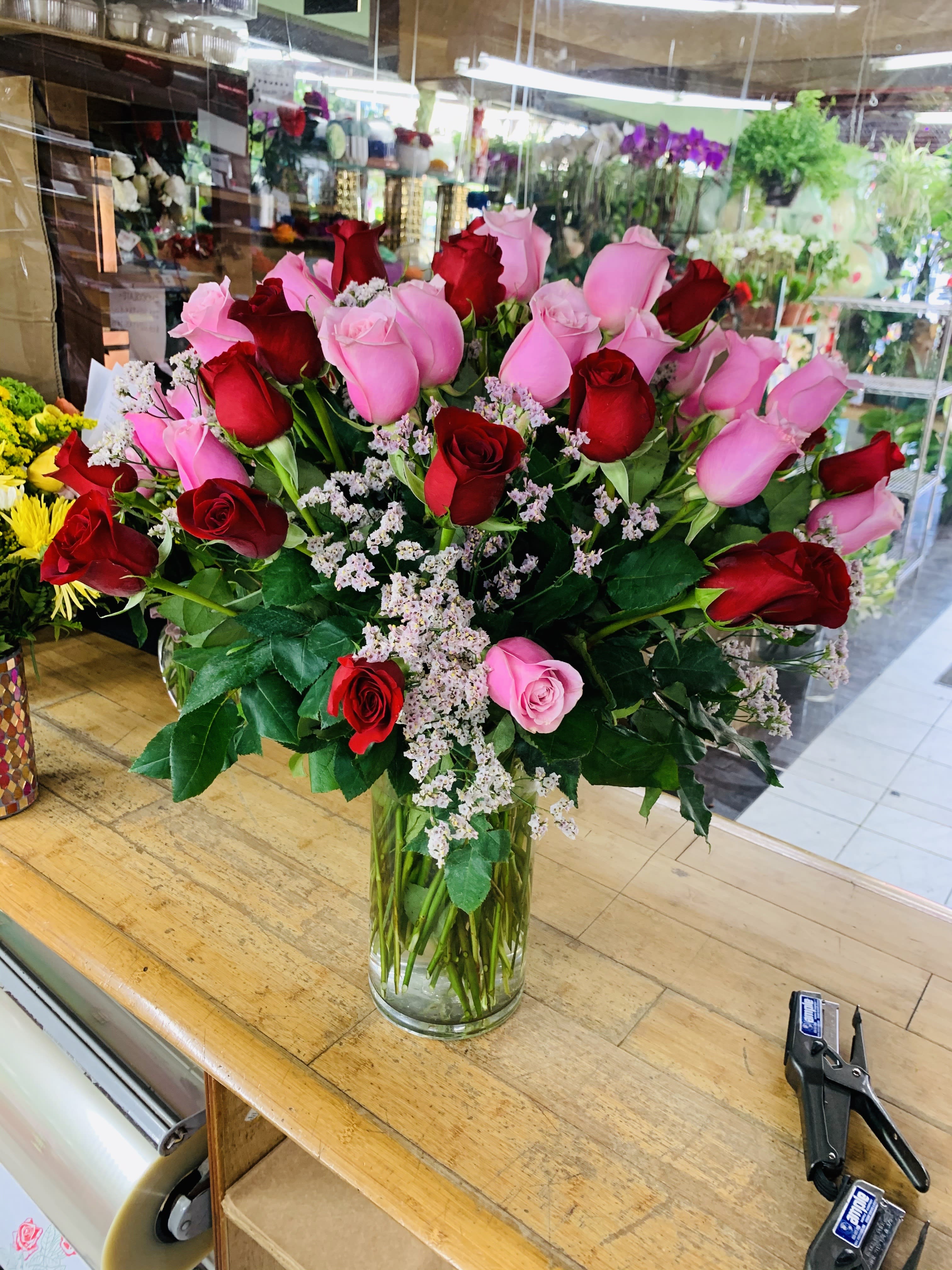 Bouquet of red and pink roses in a clear glass vase