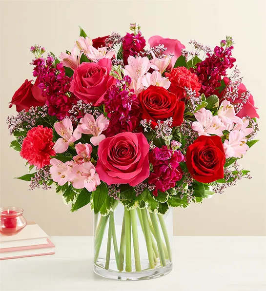 Bouquet of red and pink roses in a clear glass vase