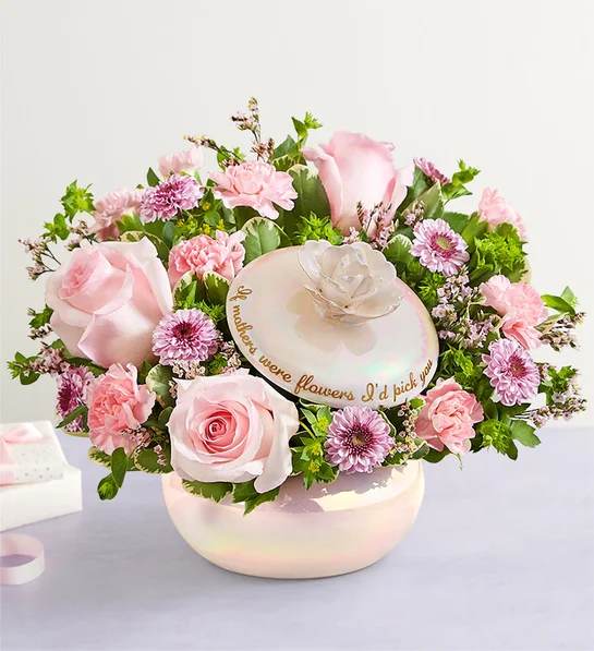 Pink roses and carnations arranged in a round hat box with a mother’s day message