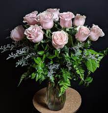 Pink roses arranged in a clear glass vase