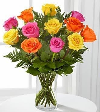 Bouquet of multicolored roses in a clear glass vase