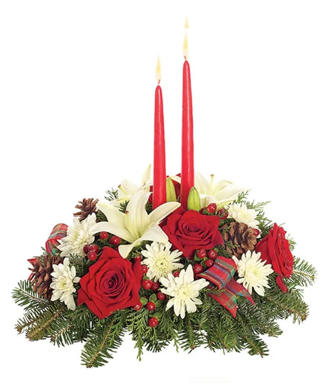 Holiday centerpiece with red roses, white lilies, and two red candles