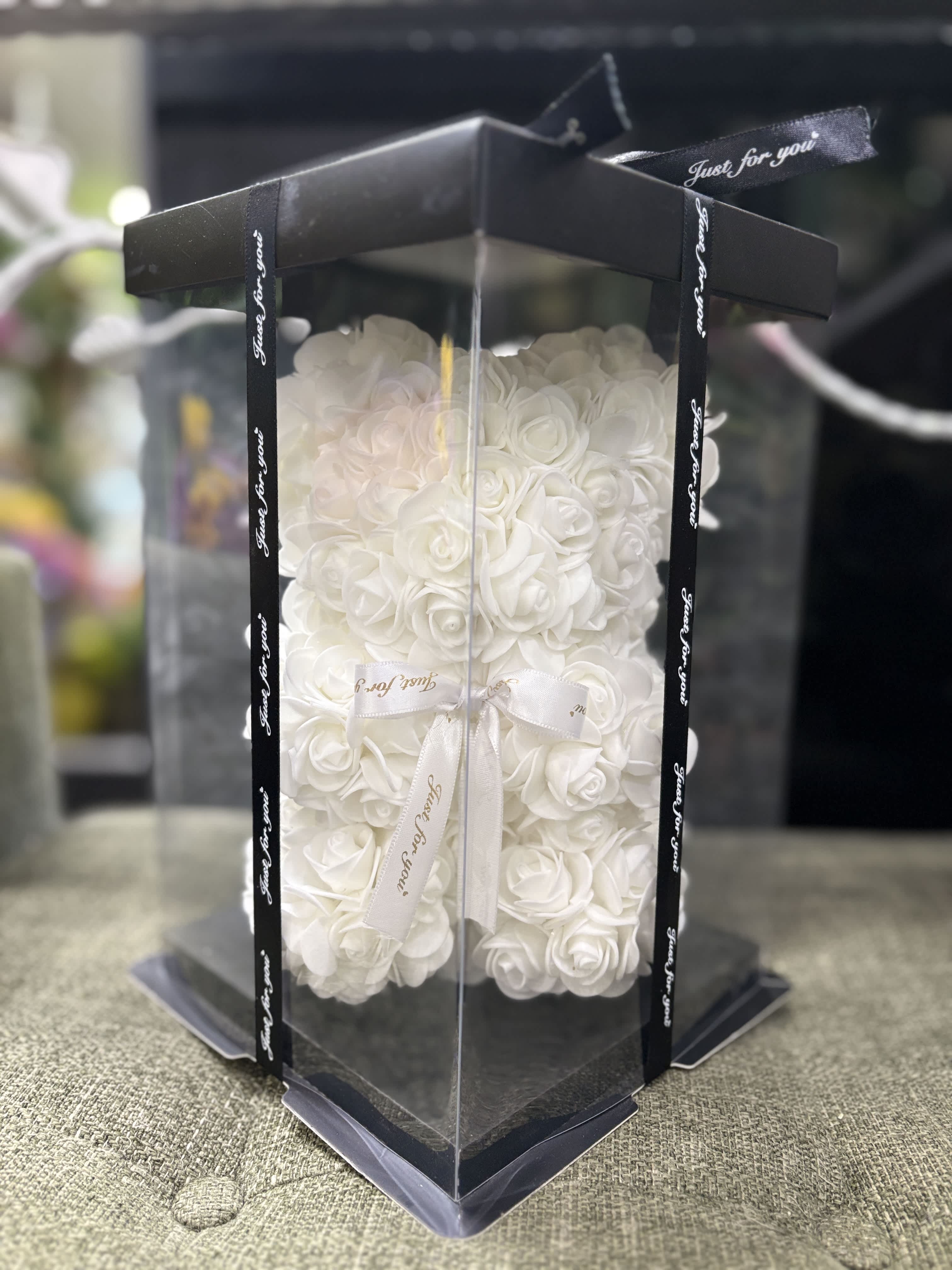 White rose teddy bear in a clear gift box with black ribbon trim
