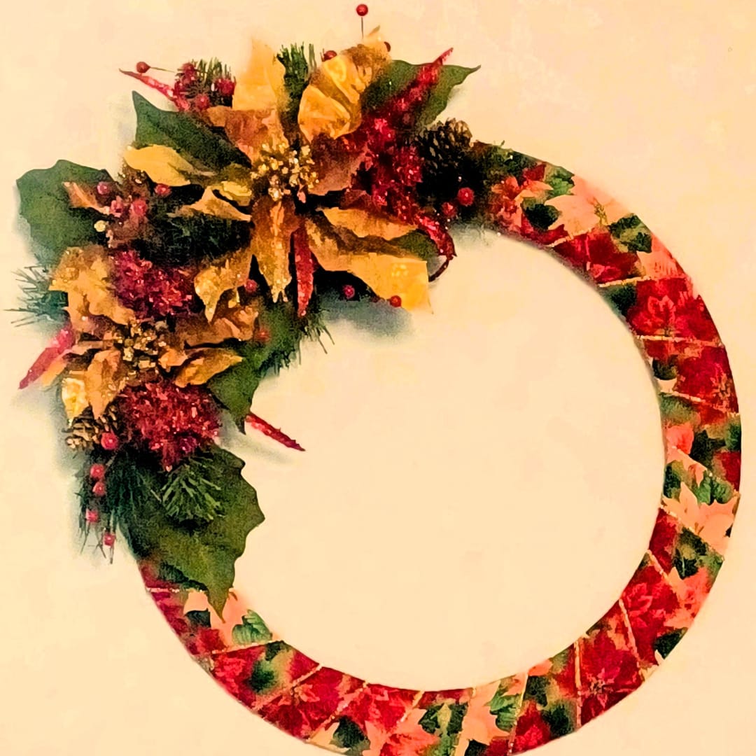 Decorative floral wreath with red and gold accents