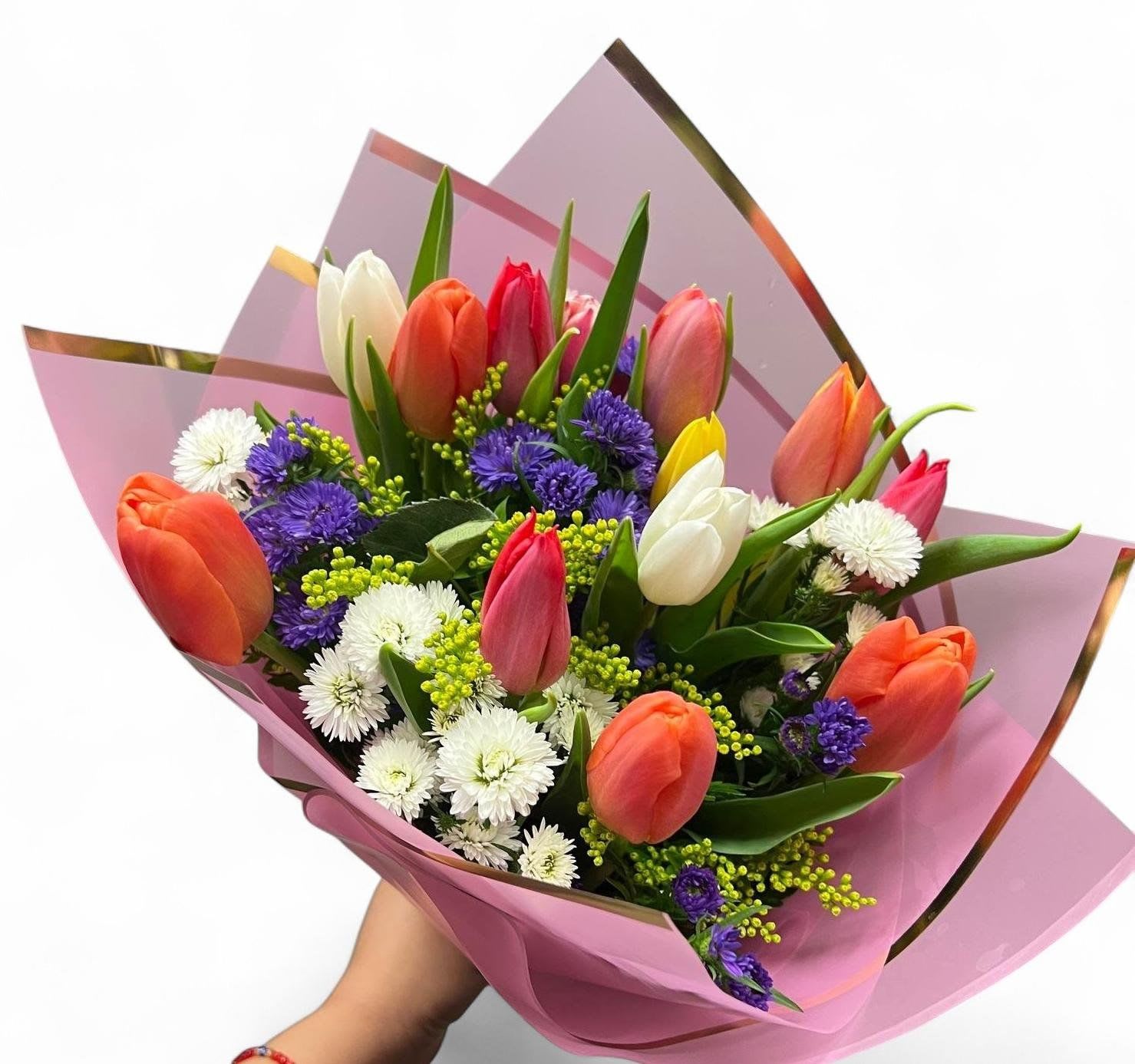 Bouquet of multicolored tulips with purple and white filler flowers