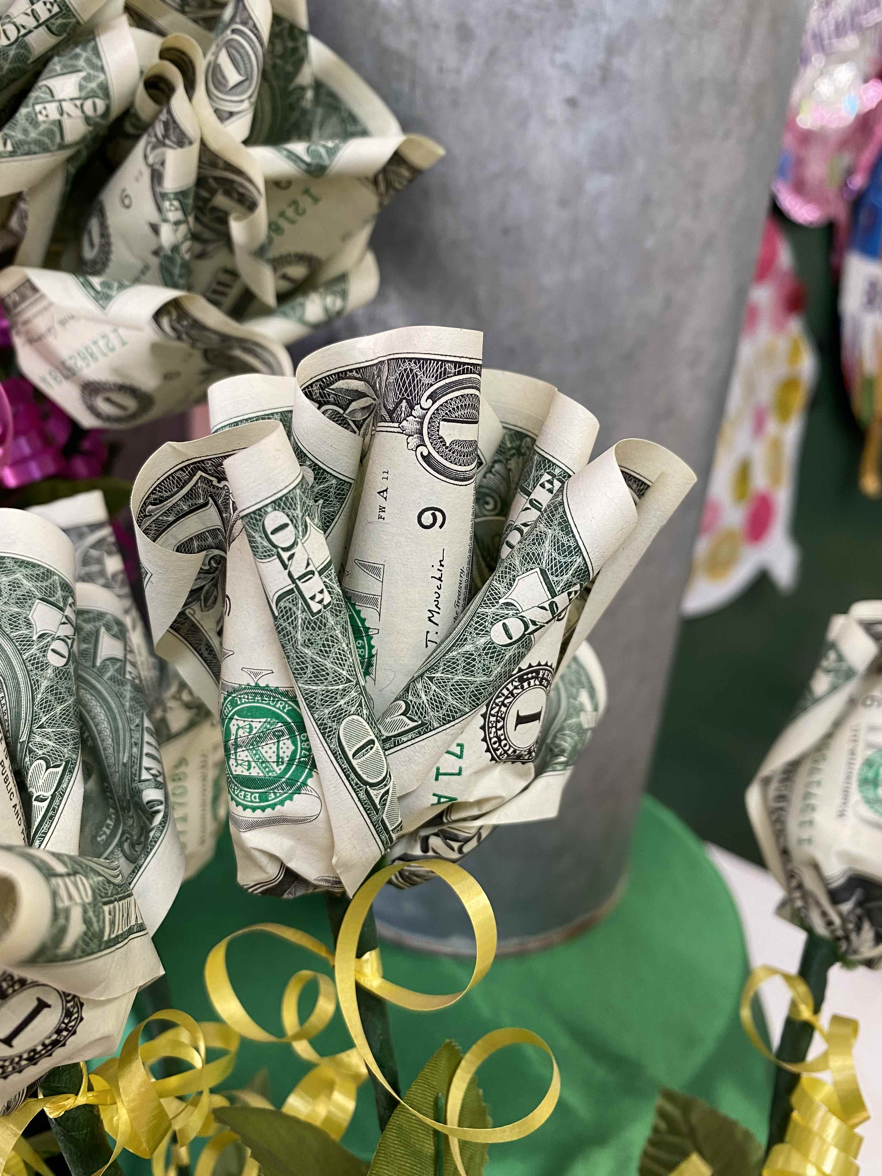 Bouquet made of folded dollar bills with yellow ribbon curls