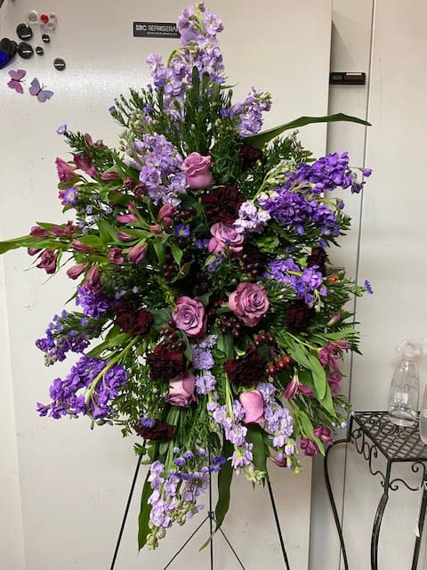 Tall purple and pink floral spray on a stand