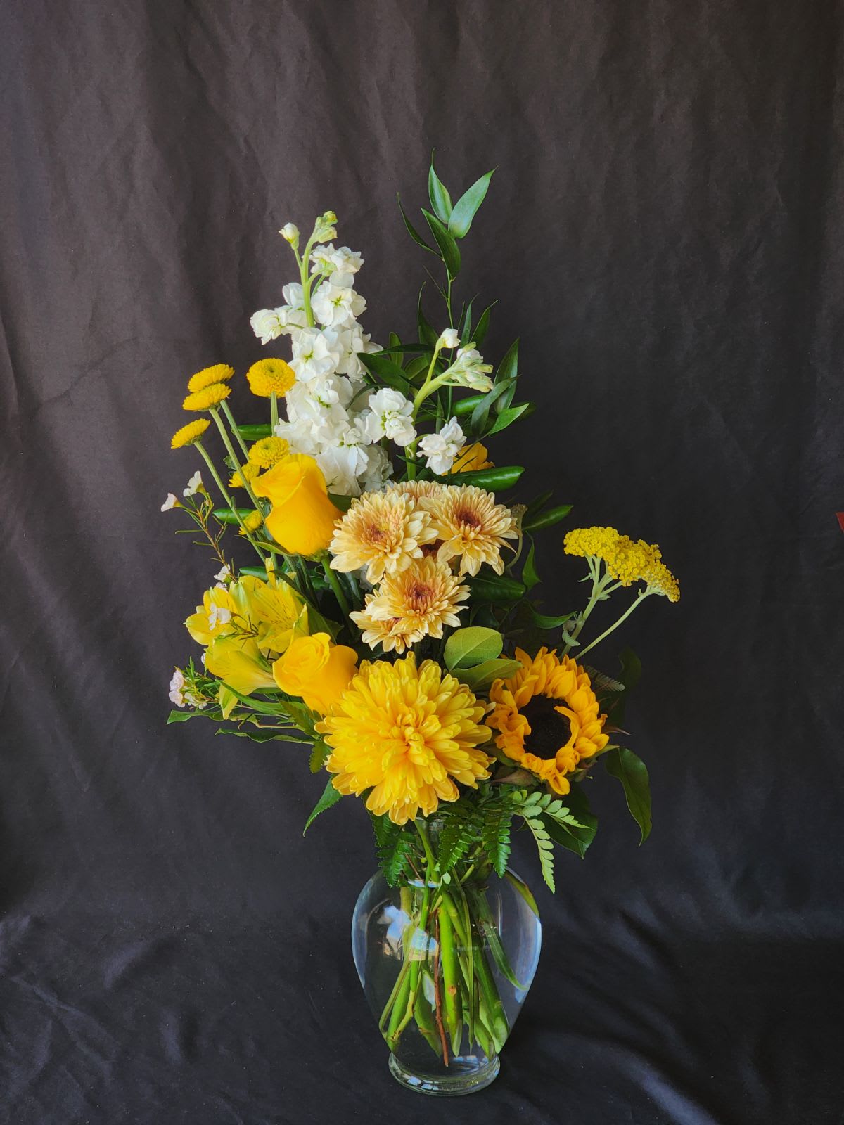 Yellow and white mixed bouquet in a clear glass vase