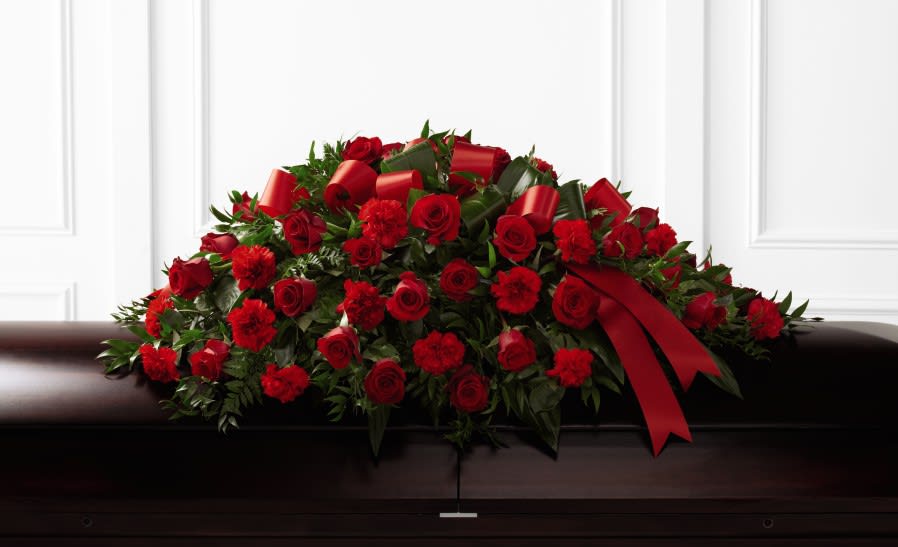 The FTD® Tribute of Life™ Casket Spray  - When saying farewell to someone you care about, our Tribute of Life™ Casket Spray beautifully honors their life. Gorgeous red blooms are a comforting, memorable and stunning expression of your sympathy. This elegant arrangement is completed with a timeless red ribbon.  Details: o Good spray is approximately 14"H x 40"W o Better spray is approximately 18"H x 40"W o Best spray is approximately 18"H x 44"W 