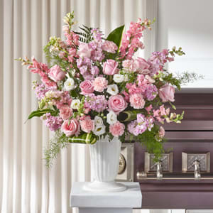 Tall pink and white floral arrangement in a white vase