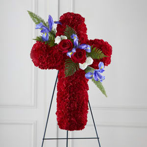 Red floral cross on a stand with blue and white accents