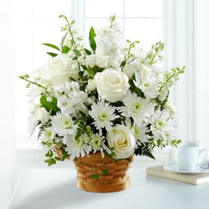 White flower arrangement in a woven basket