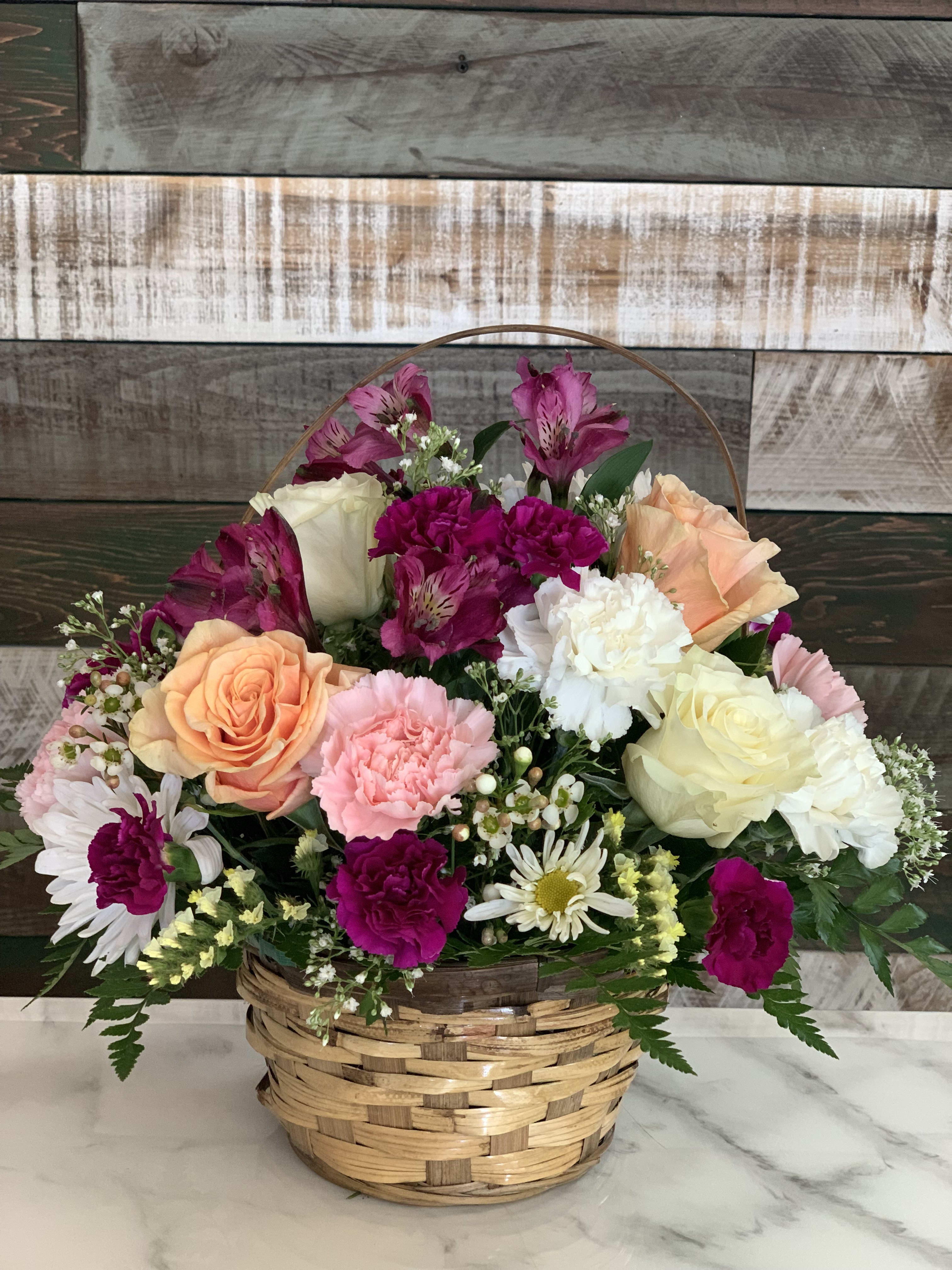 Mixed flower basket with roses, carnations, daisies, and alstroemeria