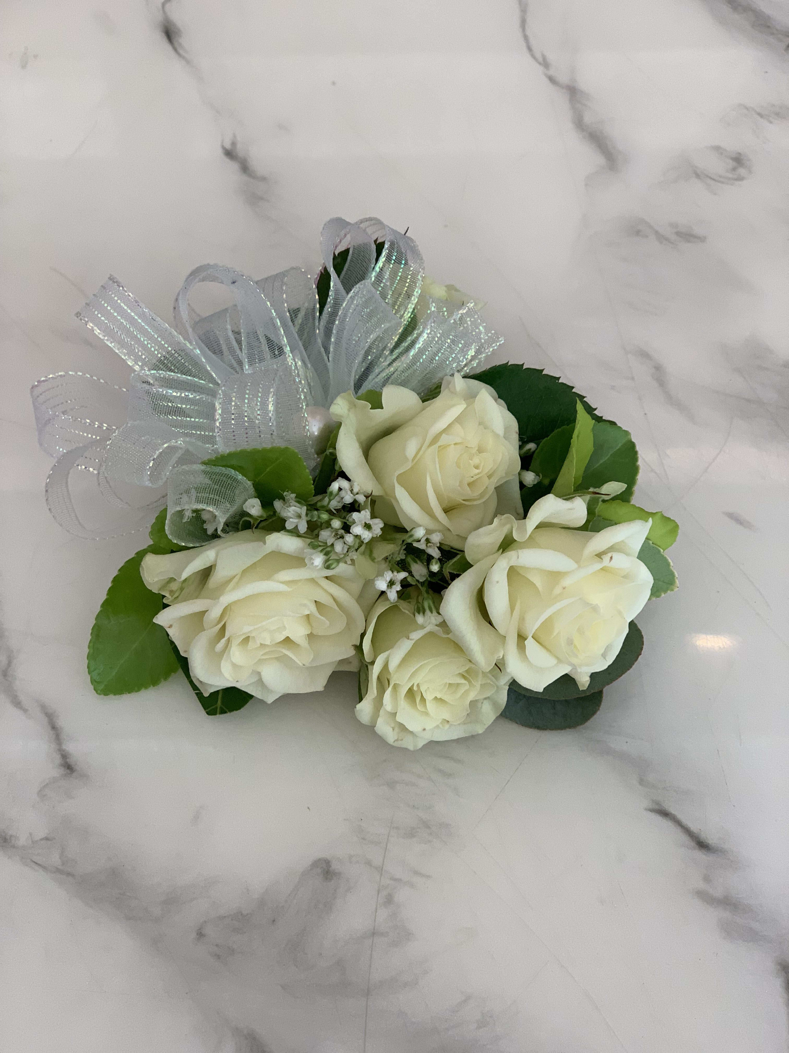 Small bouquet of white roses with a silver ribbon bow