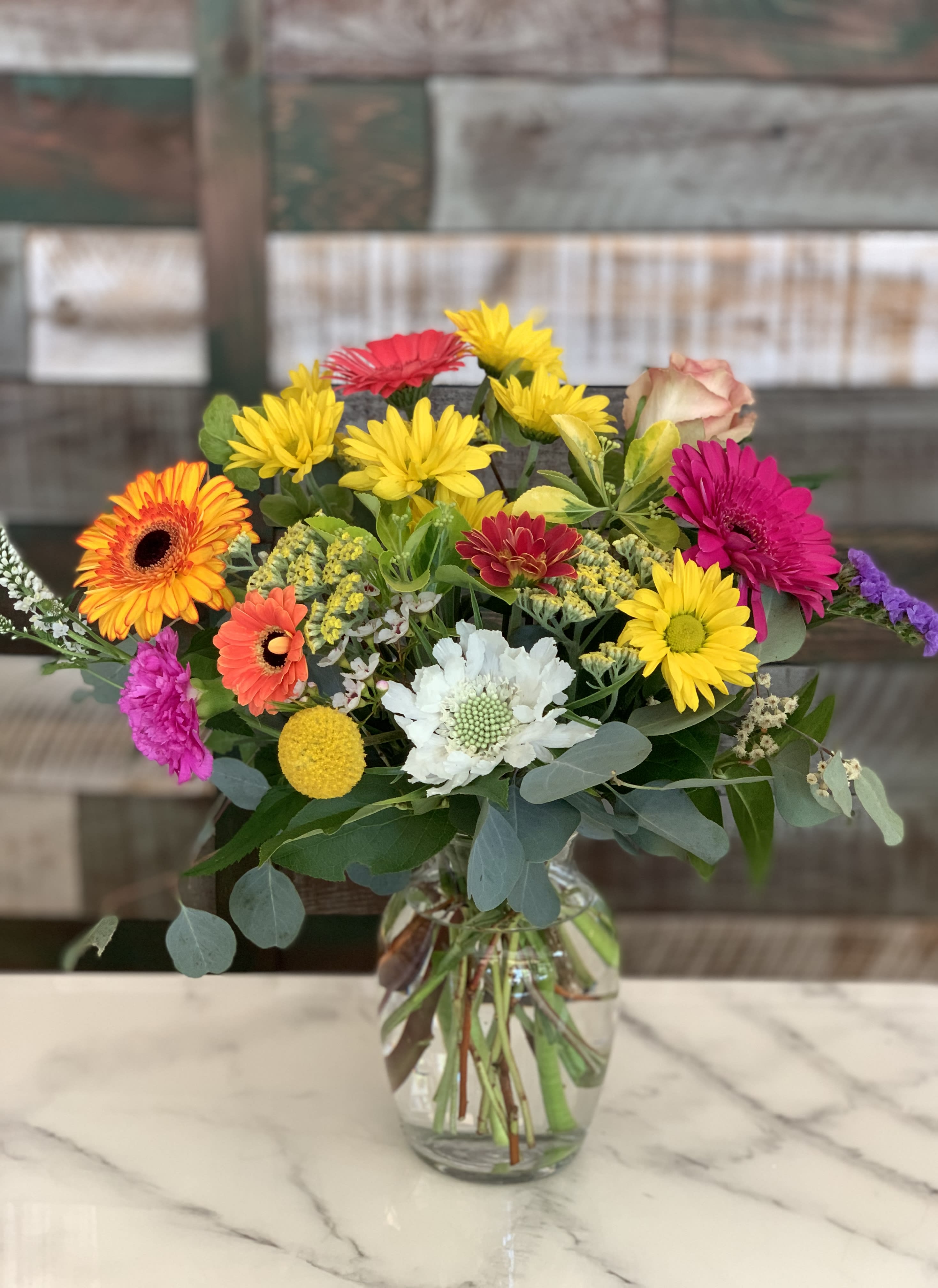 Colorful mixed bouquet in a clear glass vase