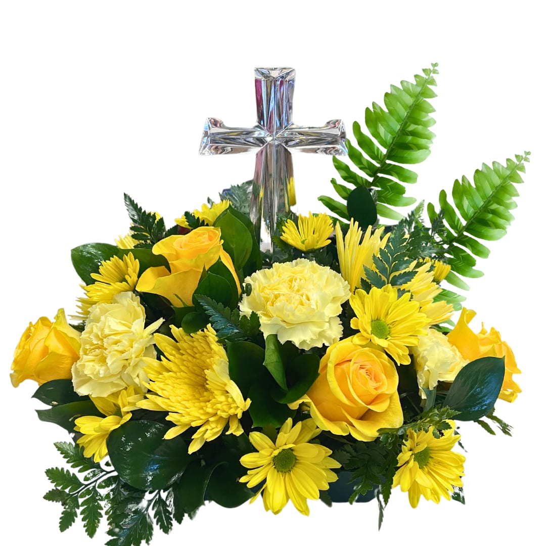 Yellow roses and daisies arranged around a silver cross
