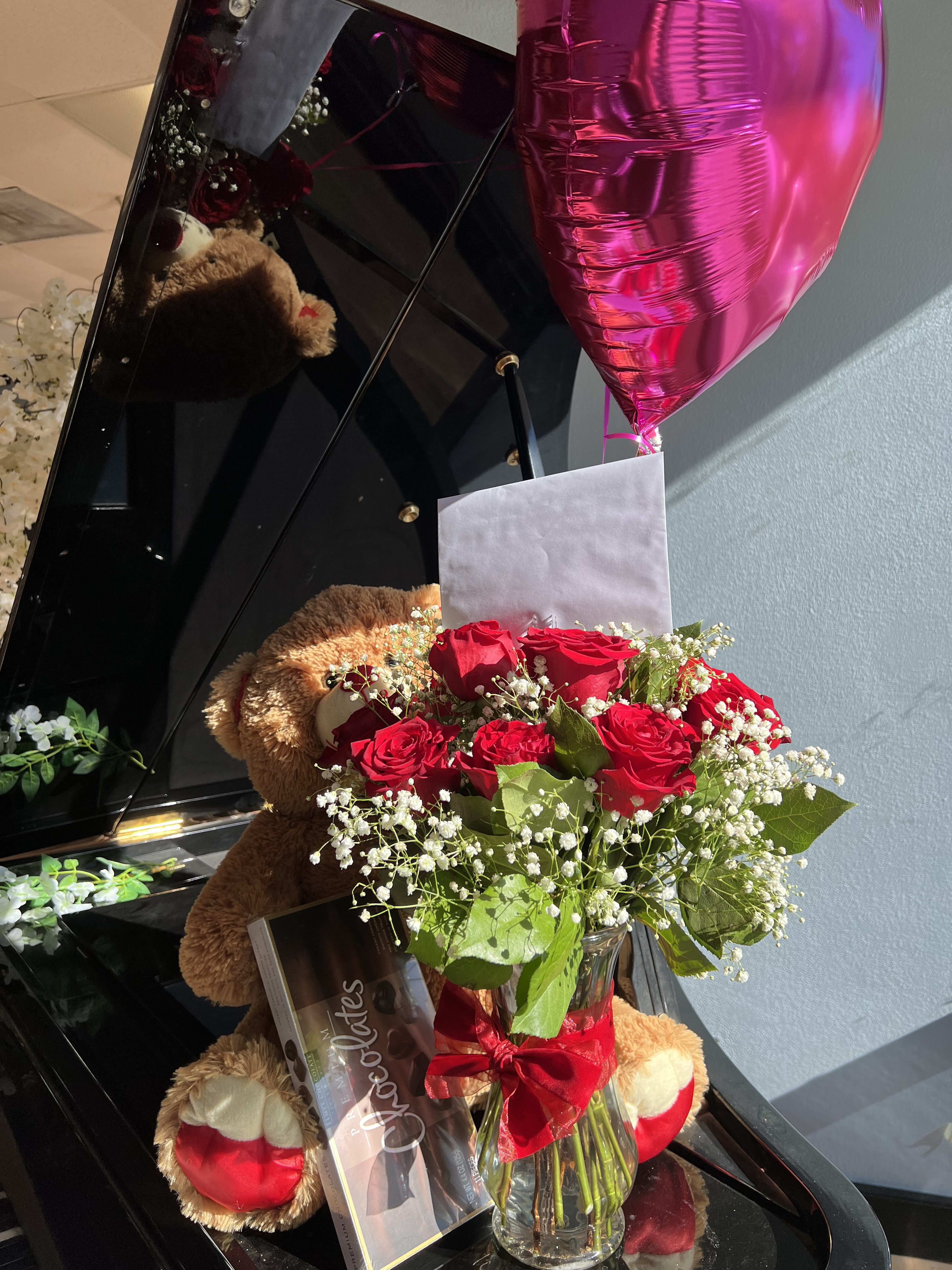 Bundle gift - traditional red roses in vase with small bear, heart balloon and box of chocolates. if you want a birthday balloon or get well soon specify in notes. Also, if there is a specific brand chocolates you can specify that as well.