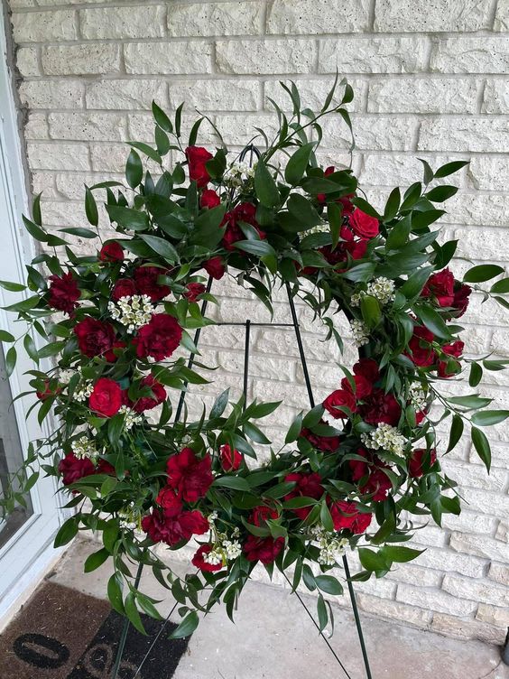 Greens and reds wreath - wreath filled with beautiful greens and pops of reds and white.   All wreaths come with complimentary sash with custom writing