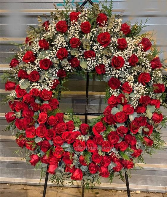 Roses and Eucalyptus wreath - Res roses, eucalyptus and babies breath with cedar greens. over 200 roses