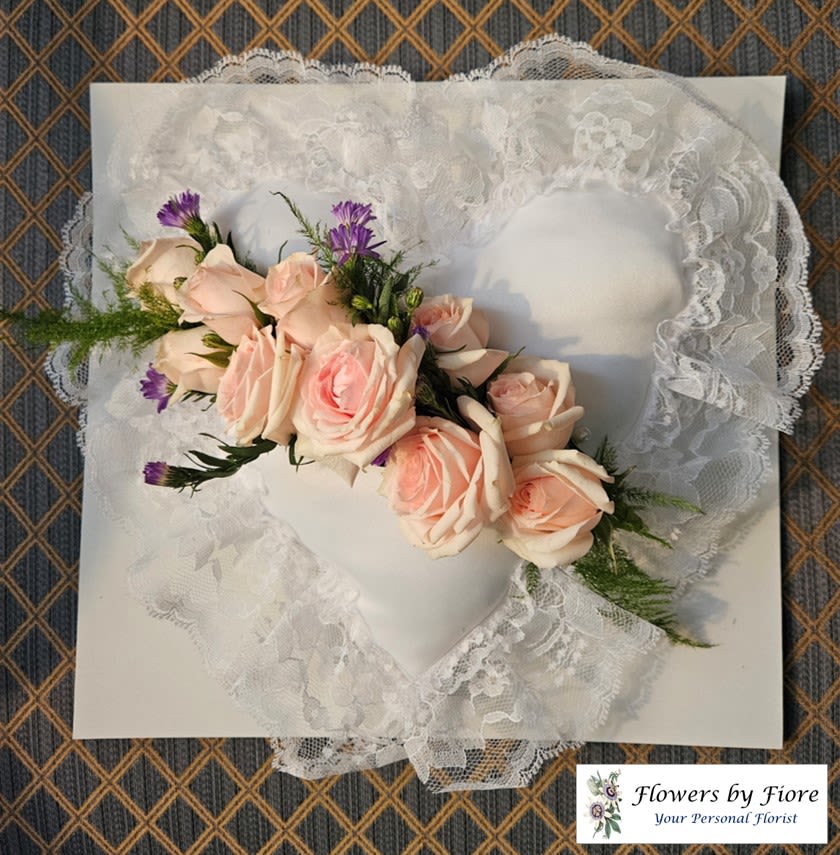 Lace heart-shaped pillow with a pale pink rose corsage
