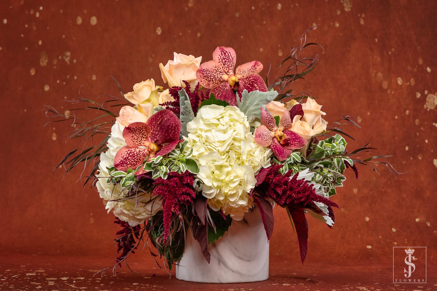 Bouquet of cream and peach flowers in a white vase
