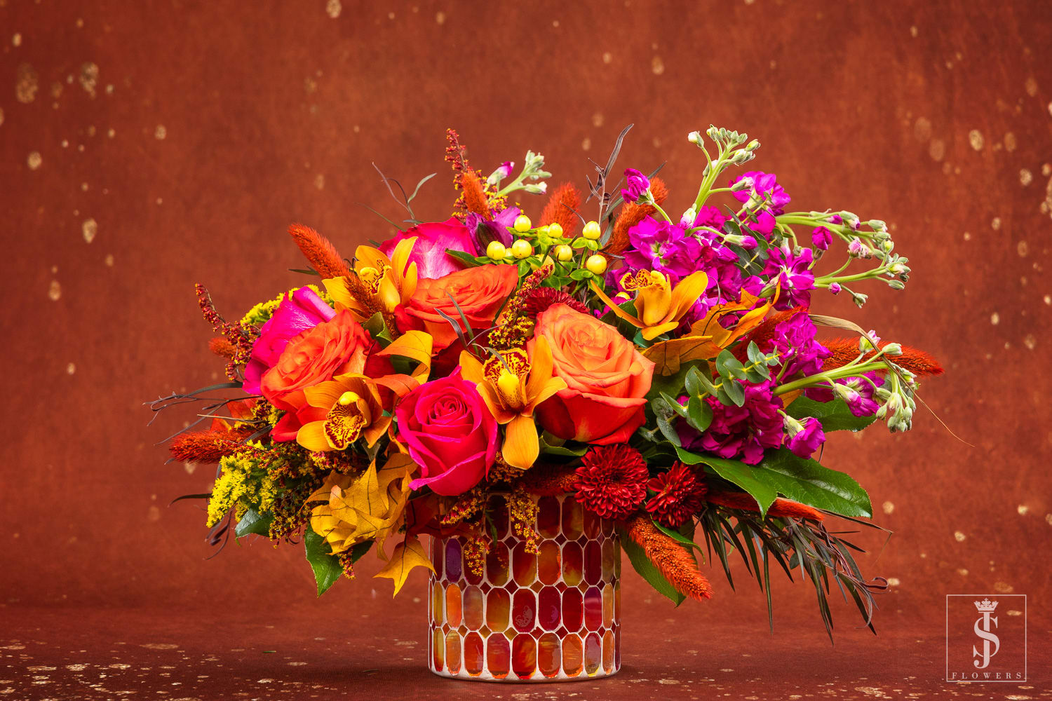 Autumn Dreams - The way the sun sets and paints a colorful sky, our bouquet of roses, orchids, daisies and mums brings life and warmth to every space. Layers of orange, bronze, purple and burgundy—with flecks of gold—are gathered together, capturing the most beautiful time of day for the people we love.  